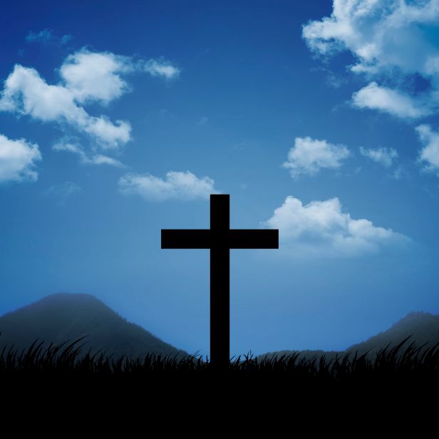 Christian cross with blue sky and cloud background
